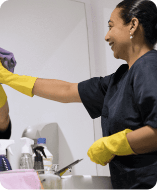 a woman cleaning a mirror