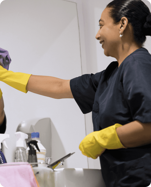 a woman cleaning a mirror