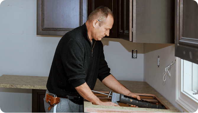a man in black outfit working on a refurnishing